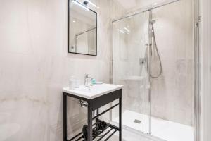 a white bathroom with a sink and a shower at Palazzo Accademia in Florence +119 photos