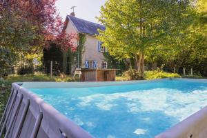 a large swimming pool in front of a house at Montauvert in Montel-de-Gelat