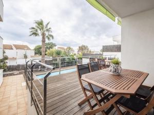 a wooden deck with a table and chairs on a balcony at R64 Deluxe Villa Déjà Vu in Calafell