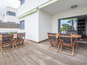 a patio with a wooden table and chairs at R64 Deluxe Villa Déjà Vu in Calafell