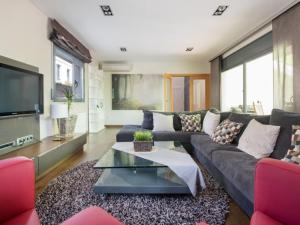 a living room with a couch and a tv at R64 Deluxe Villa Déjà Vu in Calafell