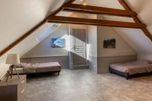 a attic room with two beds and a staircase at Montauvert in Montel-de-Gelat +9 photos