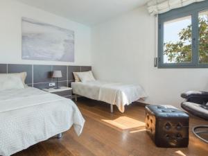 a bedroom with two beds and a suitcase on the floor at R64 Deluxe Villa Déjà Vu in Calafell +32 photos