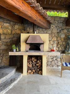 an outdoor oven with a stone wall at Villa Barelli in Cabris