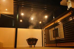 a room with a wall with a table and lights at YELAGiRI GRAND PALACE in Yelagiri +22 photos