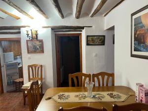 a dining room with a wooden table and chairs at Casa Rural Vicenta in Benizar +7 photos