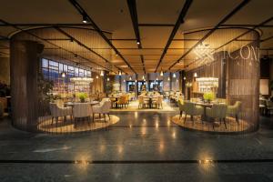 a restaurant with tables and chairs in a building at Seedamm Plaza in Pfäffikon