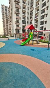 a playground with a green slide in a park at Anandam in Vrindāvan