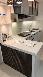 a kitchen with a counter with two plates on it at Anandam in Vrindāvan