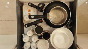 a drawer filled with cups and a pot and pans at Anandam in Vrindāvan +33 photos
