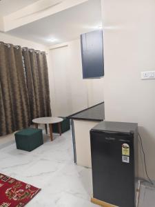 a kitchen with a counter and a table in a room at Ramashraya in Indore