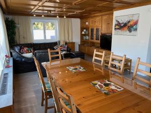 a kitchen and living room with a wooden table and chairs at Ferienhaus Holiday in Radstadt