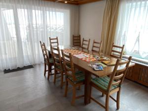 a dining room with a wooden table and chairs at Ferienhaus Holiday in Radstadt
