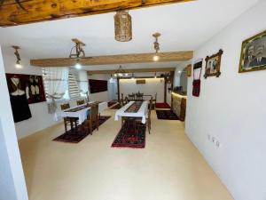 a room with tables and rugs on the floor at Domaćinstvo Koprivica in Zapolje +36 photos