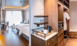 a hotel room with a bedroom with a bed and a desk at Dusit Thani Himalayan Resort Dhulikhel, Nepal in Dhulikhel