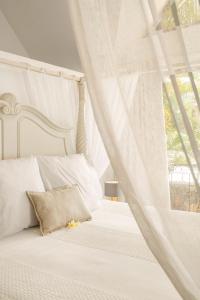 a bedroom with a white bed and a window at Sunset View by JuMa in Rivière Noire