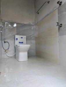a bathroom with a toilet and a shower at Gandhara Tent camping in Vagamon