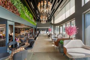 a lobby of a restaurant with chairs and tables at Limak Lara Deluxe Hotel & Resort Antalya in Lara