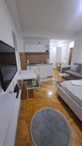 a living room with a couch and a table at Top Spot Studio in Ohrid +2 photos