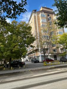 a building with cars parked on the side of a street at Top Spot Studio in Ohrid