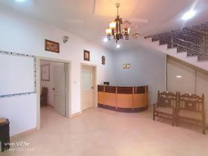 an empty room with a stage and stairs in a building at Hotel Marvi Multan in Multan