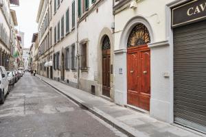 an empty street with a red door on a building at Palazzo Accademia in Florence