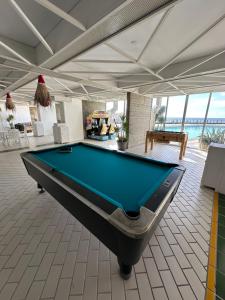 a pool table in the middle of a room at St Paul Resort in Safra