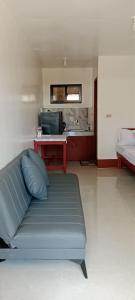 a blue couch in a room with a microwave at Mangas Residents in El Nido