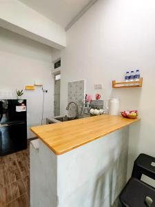 a kitchen with a wooden counter top in a room at Sunny Nest in Gopeng