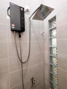 a shower in a bathroom with a shower at Sunny Nest in Gopeng +21 photos