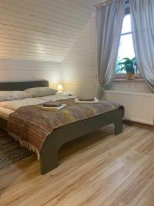 ein Schlafzimmer mit einem großen Bett und einem Fenster in der Unterkunft Stikāni in Bernāni
