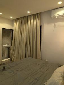 a bedroom with a bed and a window with a sink at Cyril O Apartment in Lagos