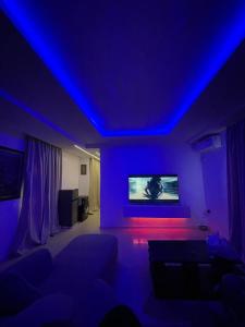 a living room with blue lights and a couch at Cyril O Apartment in Lagos