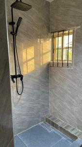 a shower with a shower head in a bathroom at Cyril O Apartment in Lagos