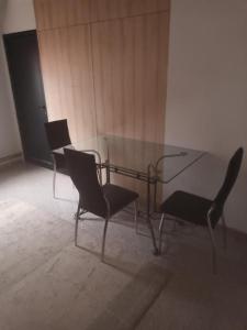 a glass table and chairs in a room at Blue point in Kragujevac +2 photos