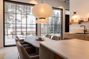 a kitchen with a table and chairs and a large window at New Seaside Villa with Beach Sauna and Panoramic Views in Porvoo +26 photos