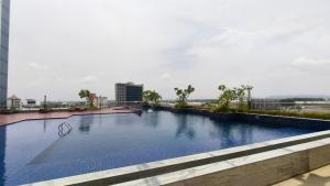 a large swimming pool on top of a building at SleepRest @ Pollux Habibie in Batam Center