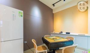 a room with a table and chairs and a refrigerator at 不想回家民宿-免費停車-寵物友善-無門禁24小時進出-東森文旅-包棟優惠中 in Yuanshan