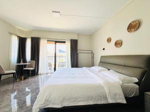 a bedroom with a large bed and a balcony at West14 Tamarin Bay,Studio in Tamarin