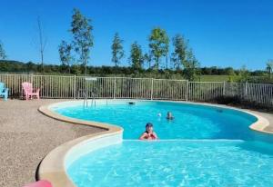 a young child swimming in a swimming pool at Le Bruant des Roseaux in Villegusien Le Lac +17 photos