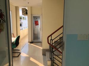 a hallway with a staircase and a stair case at Homestay 150 in Ho Chi Minh City