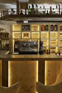 a bar with chairs in front of a counter at Hotel ZUM STERNENHOF in Kössen