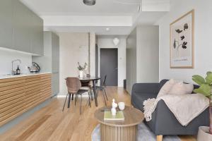 a living room with a couch and a table at Modern & Stylish Apartment with Private Balcony in Aarhus