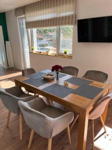 a dining room table with chairs and a large window at Green view 180 in Troyan