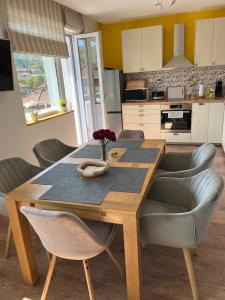 a kitchen with a wooden table with chairs and a dining room at Green view 180 in Troyan