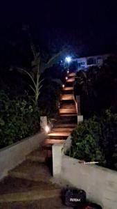 a set of stairs with lights at night at Résidence LE MÄYSA in Sada +9 photos