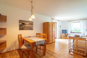 a kitchen and dining room with a table and chairs at Wabnig- der Logenplatz in der Natur in Moosburg