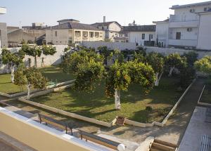 a view of a park with trees and benches at Augustea Travel Rooms in Frignano