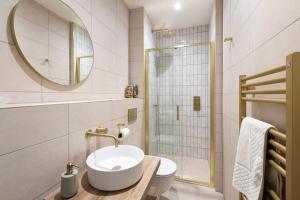 a bathroom with a sink and a toilet and a mirror at Brockview House - Eco 4 bed in Holcombe