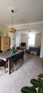 a large living room with a table and chairs at Effets Personnels in Orange